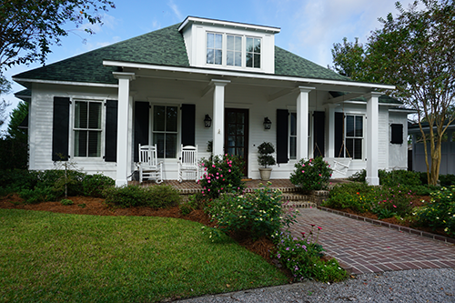 white cottage green roof